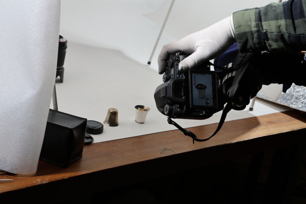 Kontio ottaa kuvia näyttelystä. Nämä 1940-luvun lopun pokaalit olivat purjeduskilpailun palkintoja. 