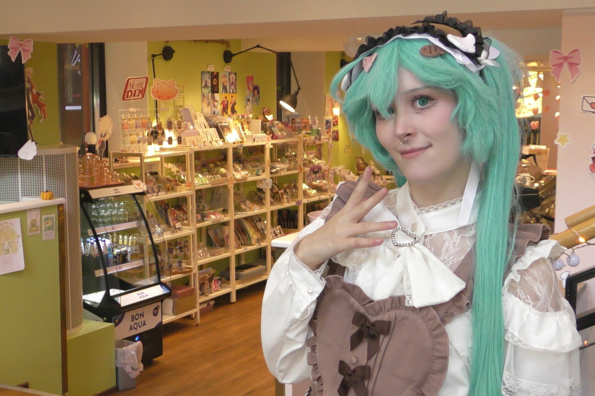 Cosplay-harrastaja Helmi Entonen on pukeutunut Hatsune Miku -hahmoksi. Entonen on Cafe Bar Cocoro -kahvilan avustaja. Kuva: Aleksandr Shamilov